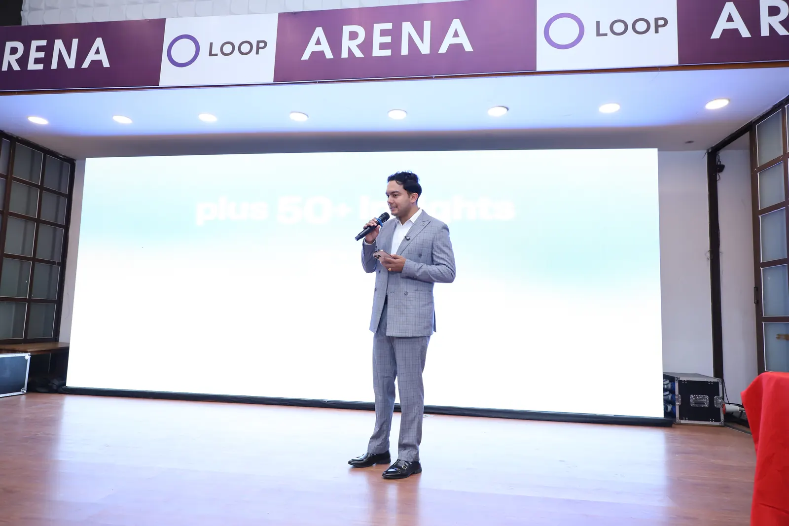 The full Loop Arena stage, with the NepalHRM presenter in front of a large LED screen showing the pitch slides